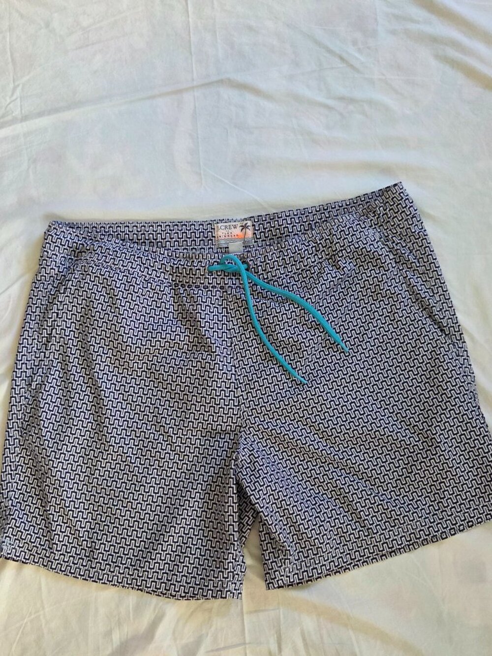 J.Crew swim briefs featuring a geometric maze-like print and a bright-colored ad